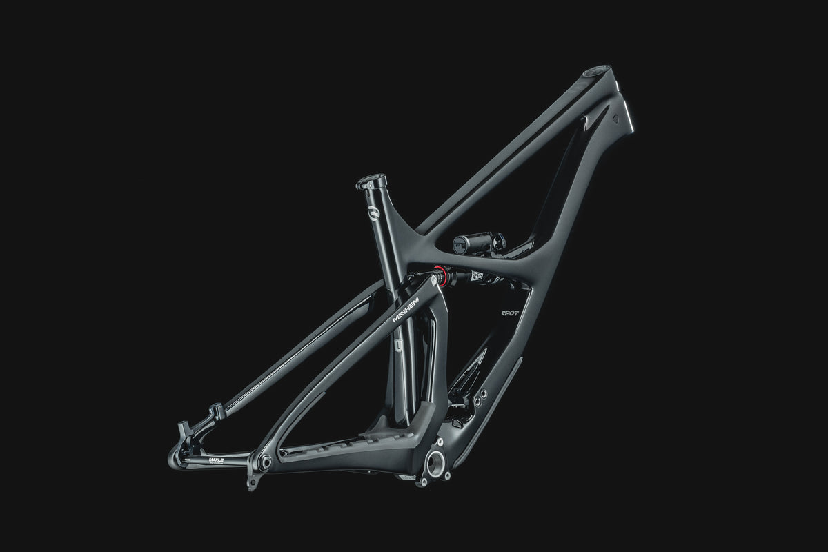 Mayhem 140 in Liquid Black — Frame and rear triangle from the non-drive side, three-quarter view