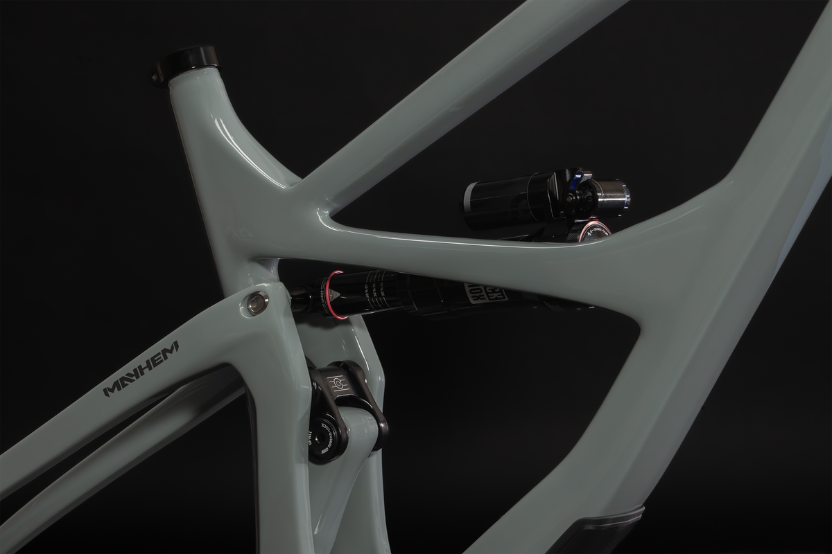 Mayhem 140 in Lichen Grey — Seat tube junction and rear shock, with the seatstay decal