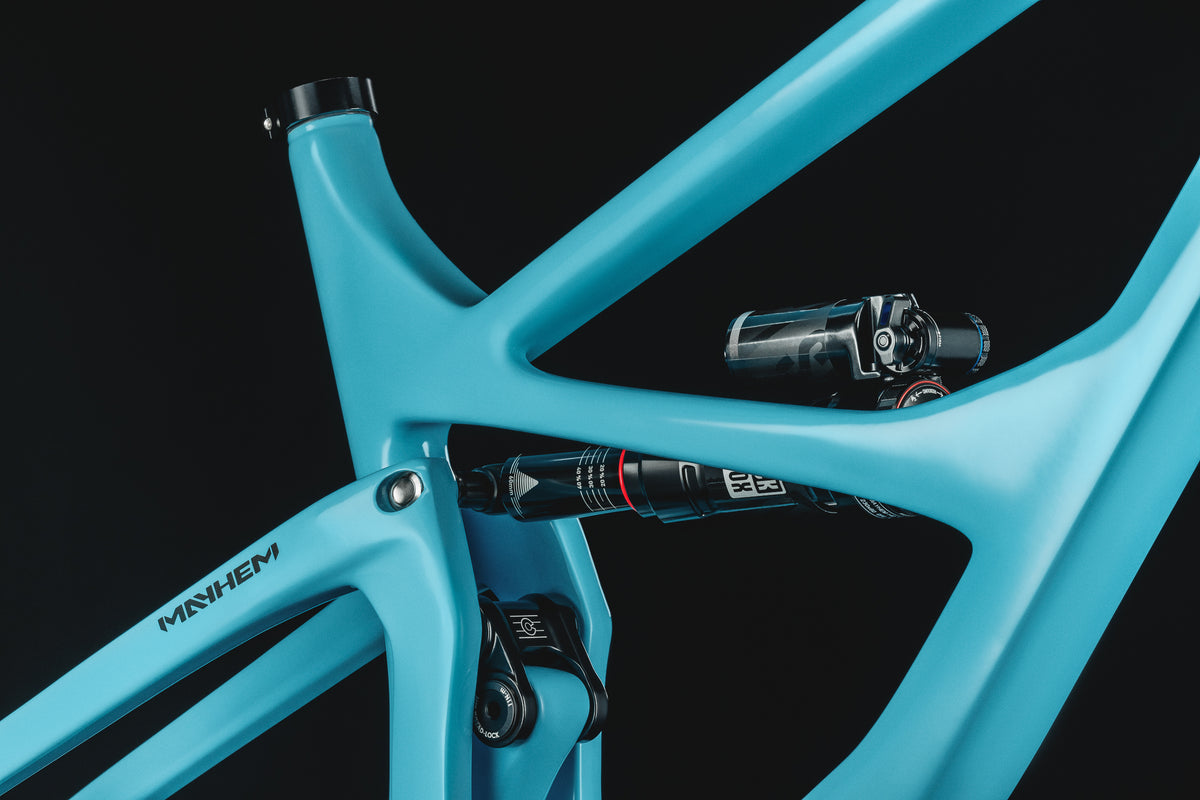 Mayhem 140 in Alpine Blue — Seat tube junction and rear shock, with the seatstay decal