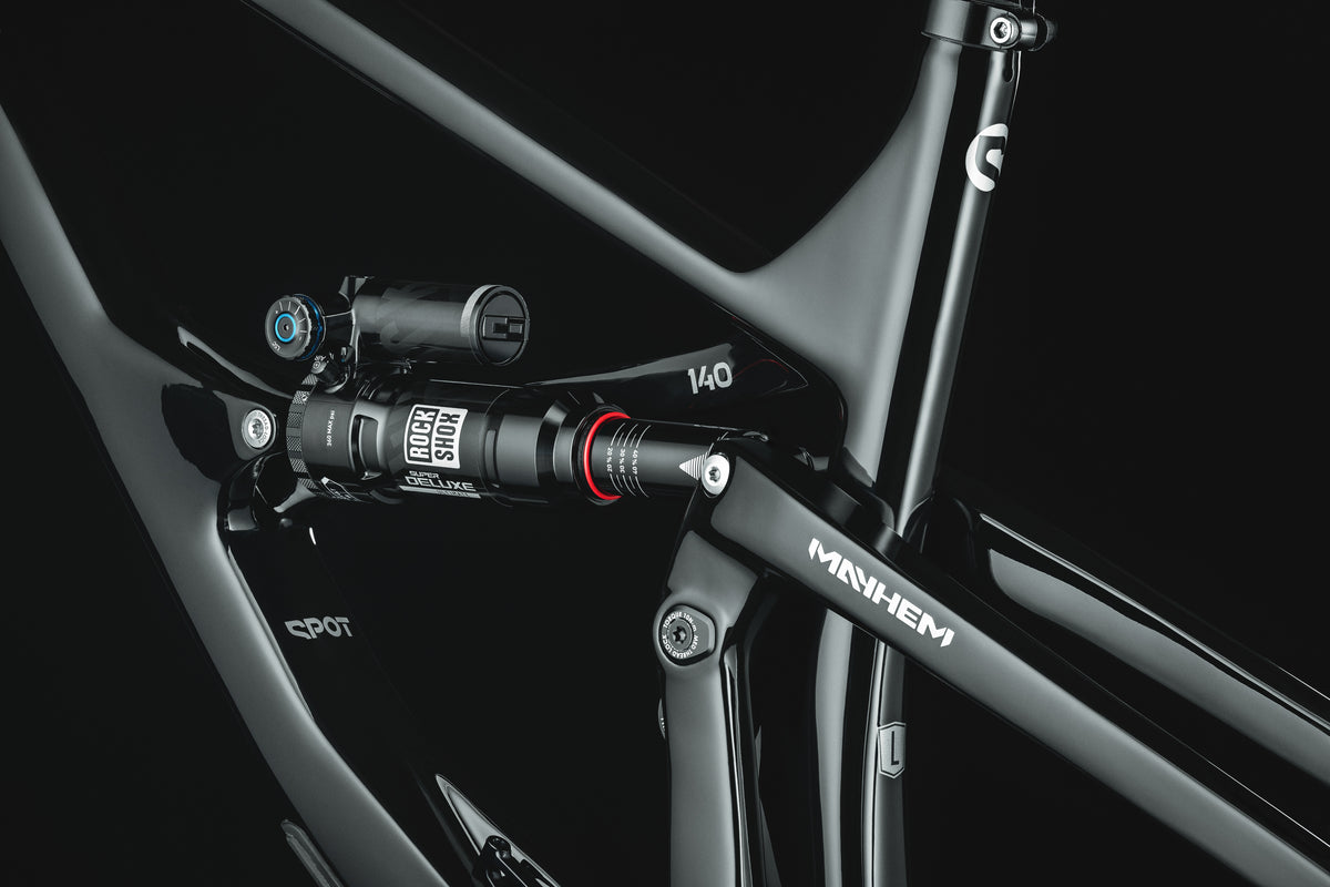 Mayhem 140 in Liquid Black — Rear shock and rocker link seen through the front triangle