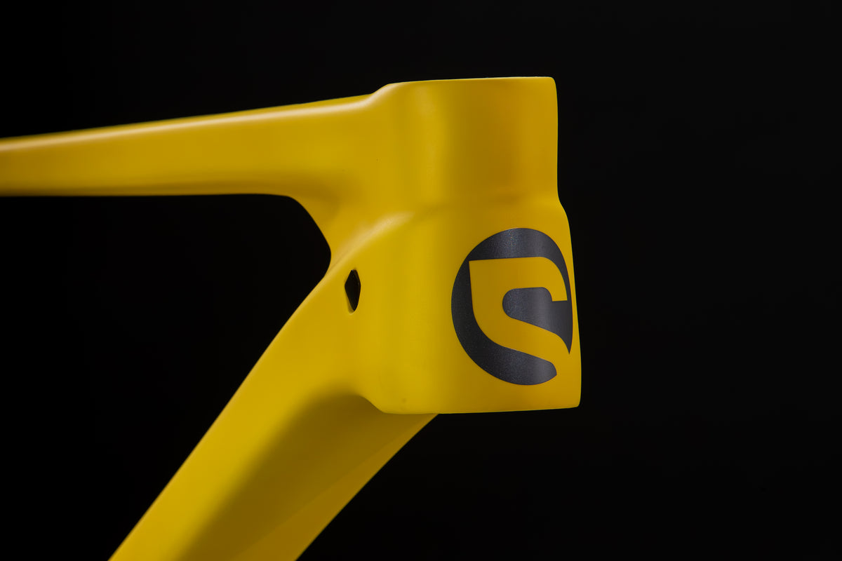 Rocker Carbon Gen 3 in Aspen Glow — Head tube with the Spot logo and internal cable port