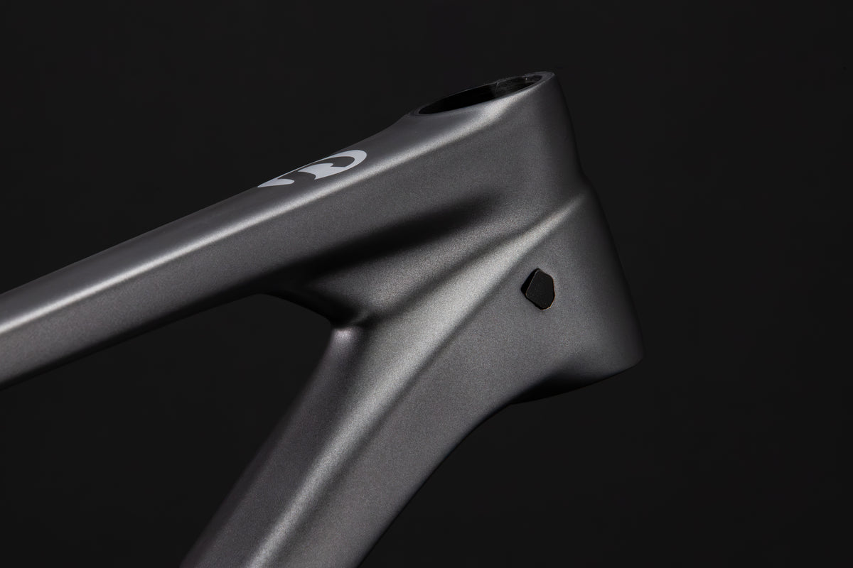 Rocker Gen 3 carbon frame in Talus Grey, internal cable port on the down tube behind the head tube