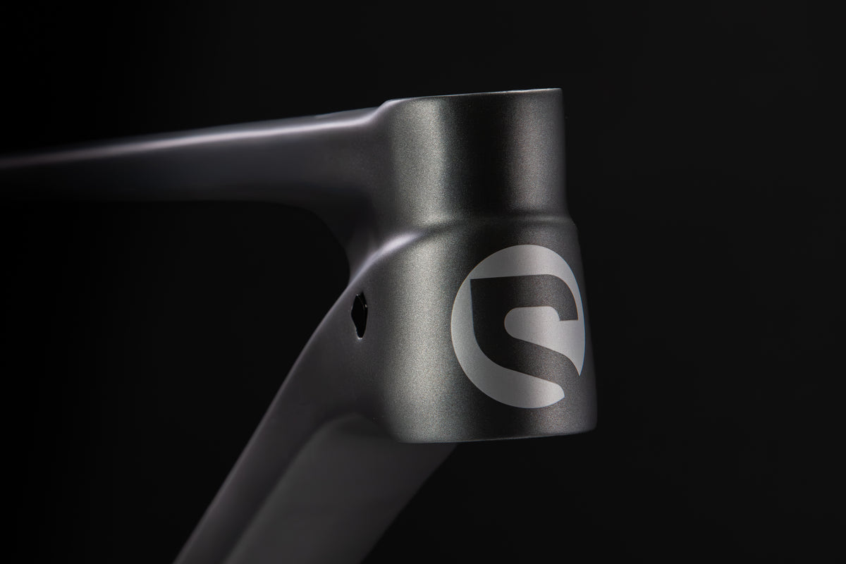 Rocker Carbon Gen 3 in Talus Grey — Head tube with the Spot logo and internal cable port